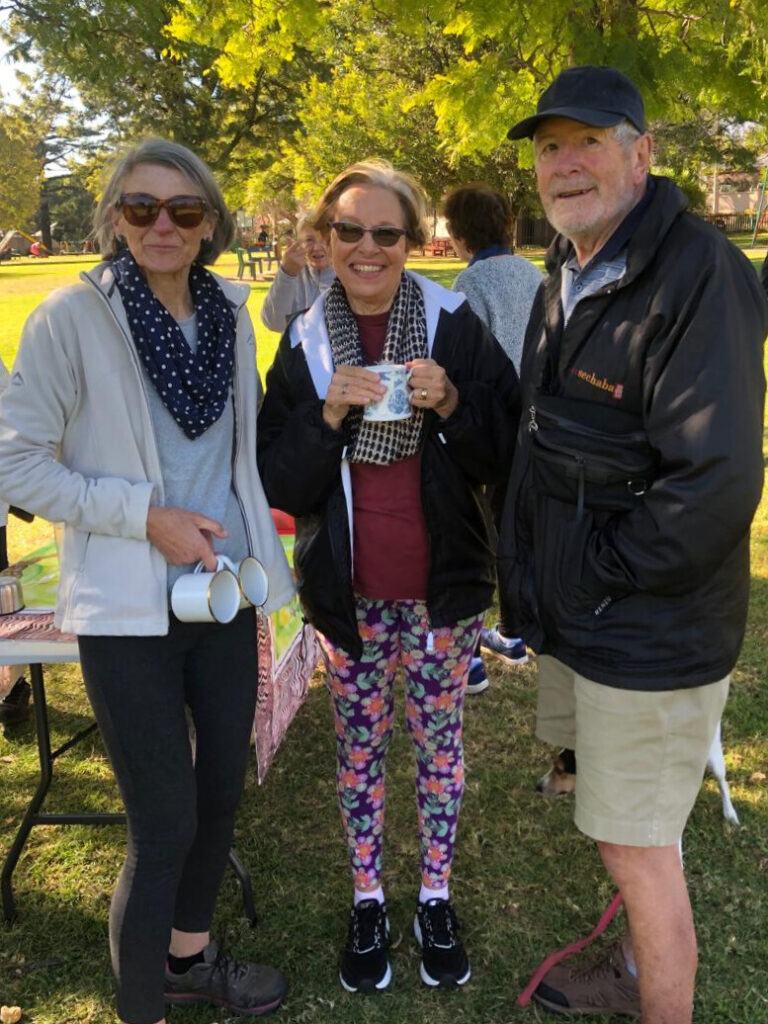 People over 60 socializing outdoors after fitness class.