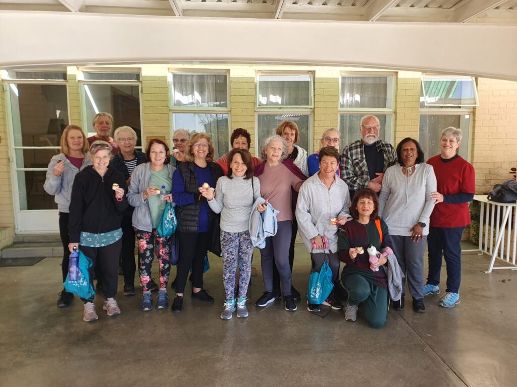Indoor fitness class for people over 60 celebrating movement together.
