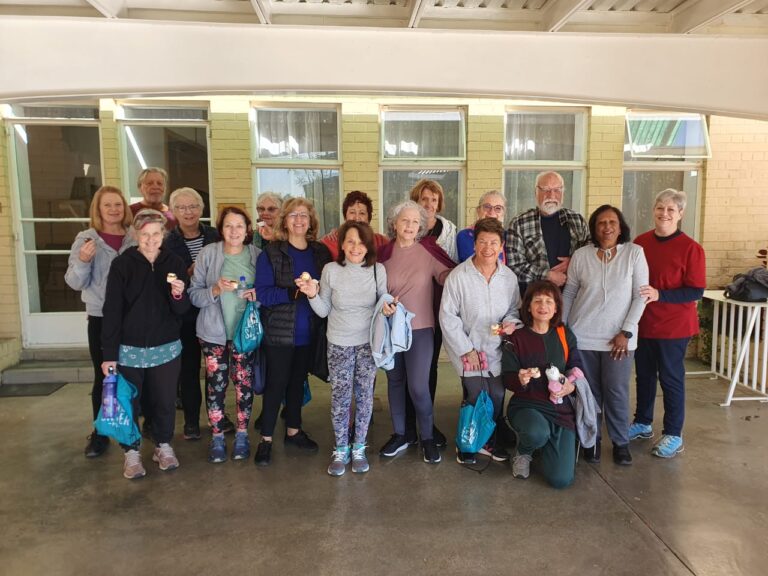 Indoor fitness class for people over 60 celebrating movement together.